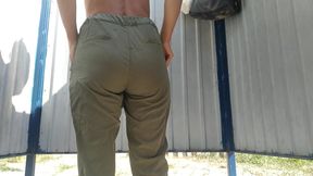 Tanned slim beauty changing clothes on the beach in the locker room